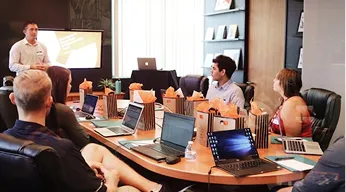 SF Civic Tech members collaborating around a table with laptops